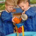 Two children playing with water