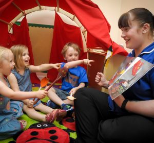 Reading a book with three children inside