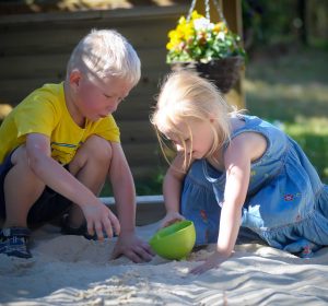 Two children playing in the sandpit